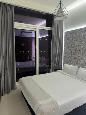 a bedroom with a bed and a large window at Apartment Downtown Dubai in Dubai