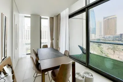 a dining room with a table and a large window at Private Room in Luxurious 3BR Apartment with BURJ KHALIFA view in Downtown near Dubai Mall in Dubai