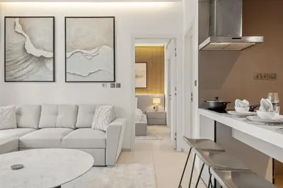 a living room with a couch and a table at FIRST CLASS 1BR Luxury Meets Simplicity in Dubai