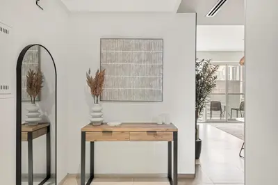 a room with a table and a mirror at FIRST CLASS 1BR Luxury Meets Simplicity in Dubai