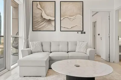 a living room with a couch and a table at FIRST CLASS 1BR Luxury Meets Simplicity in Dubai