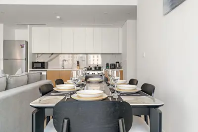 a dining room with a table with wine glasses at FIRST CLASS 1BR Stylish Beachfront Escape in Dubai