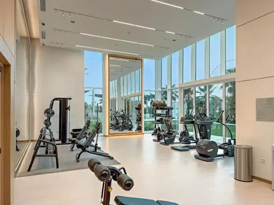 a gym with a bunch of exercise equipment in a building at FIRST CLASS 1BR Stylish Beachfront Escape in Dubai