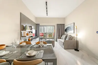 a living room with a table and a couch at FIRST CLASS 2BR Pool View and near Dubai Mall in Dubai