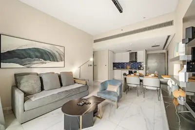 a living room with a couch and a table at FIRST CLASS 2BR Pool View and near Dubai Mall in Dubai
