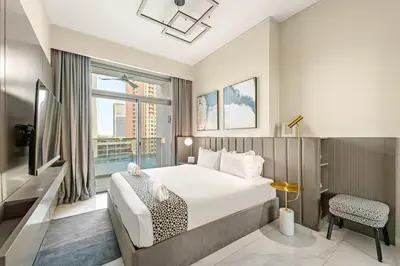 a hotel room with a bed and a window at FIRST CLASS 2BR Pool View and near Dubai Mall in Dubai