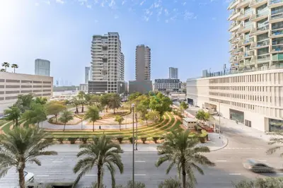a view of a city with palm trees and buildings at Furnished Studio Near Circle Mall, Close to Parks, Jogging Tracks, Bus Stops And Grocery Stores - Damac Ghalia, JVC by Deluxe Holiday Homes in Dubai