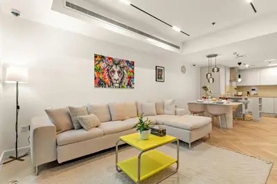 a living room with a couch and a table at Luxury 2BR in Dubai Marina Balcony, Views, Walk to Metro & Tram in Dubai
