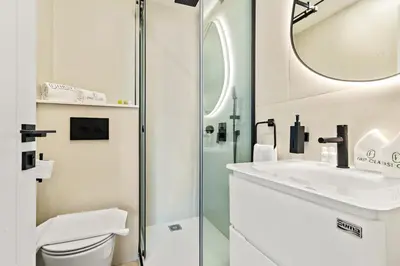 a bathroom with a toilet and a sink and a mirror at Luxury 2BR in Dubai Marina Balcony, Views, Walk to Metro & Tram in Dubai