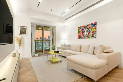 a living room with a couch and a table at Luxury 2BR in Dubai Marina Balcony, Views, Walk to Metro & Tram in Dubai