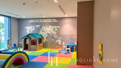 a room with a play room with a wall with a mural at LUX 52 42 Deluxe Marina View Suite 3 in Dubai