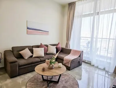 a living room with a couch and a table at Majestic Retreat - 1BR Dubai in Dubai