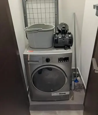 a washing machine with a pot on top of it at Majestic Retreat - 1BR Dubai in Dubai