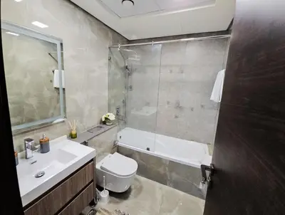 a bathroom with a toilet and a sink and a shower at Majestic Retreat - 1BR Dubai in Dubai
