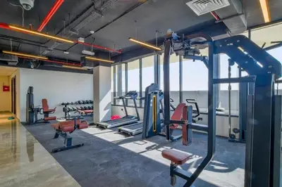 a gym with several treadmills and exercise equipment at Southside Spacious & Sleek - 2BR in Dubai