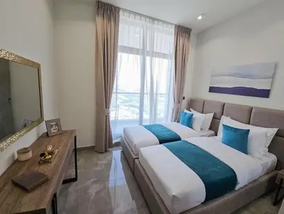 a hotel room with two beds and a window at Southside Spacious & Sleek - 2BR in Dubai