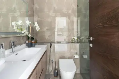 a bathroom with a white toilet and a sink at Southside Spacious & Sleek - 2BR in Dubai