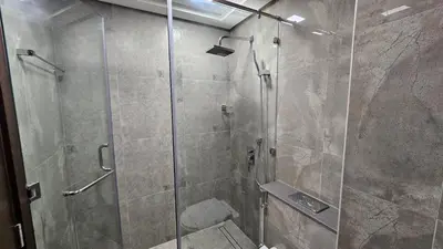 a bathroom with a shower with a glass door at Studio Luxe Dubai South in Dubai