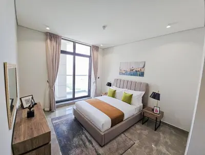 a bedroom with a large bed and a large window at The Executive Nest -1BR in Dubai in Dubai