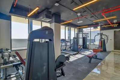 a gym with several treadmills and exercise machines at The Executive Nest -1BR in Dubai in Dubai