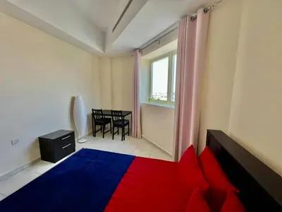 a room with a red and blue bed and a table at Close to The World Trade Center and DIFC in Dubai