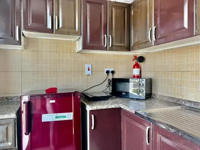 a kitchen with a red refrigerator and a microwave at Close to The World Trade Center and DIFC in Dubai
