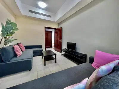 a living room with two couches and a television at Close to The World Trade Center and DIFC in Dubai