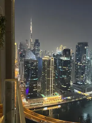 a view of a city at night with traffic at Luxury 2BR Canal front & Burj Khalifa views- High Floor in Dubai