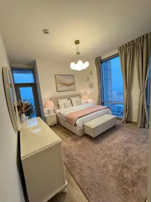 a bedroom with a bed and a large window at Luxury 2BR Canal front & Burj Khalifa views- High Floor in Dubai