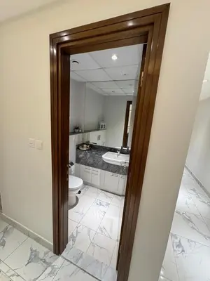 a bathroom with a toilet and a mirror at Luxury 2BR Canal front & Burj Khalifa views- High Floor in Dubai