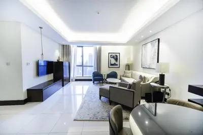 a living room with a couch and a tv at A&S Downtown Dubai in Dubai