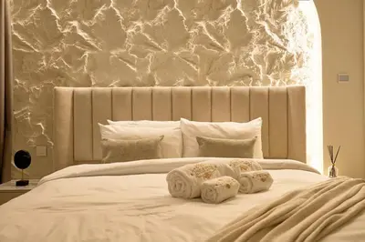 a white bed with three pillows on top of it at Luxury Apt 2BR with full burj khalifa view in Dubai