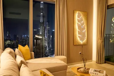 a living room with a couch and a large window at Luxury Apt 2BR with full burj khalifa view in Dubai