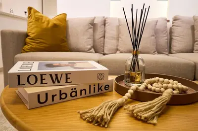 a living room with a table with a book and a box at Luxury Apt 2BR with full burj khalifa view in Dubai