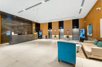 a lobby of a hospital with a blue chair at Luxury Palm Studio - Skyline Views - Rooftop Pool & Beach Access in Dubai