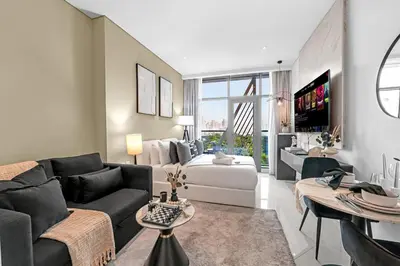 a living room with a couch and a bed at Luxury Palm Studio - Skyline Views - Rooftop Pool & Beach Access in Dubai