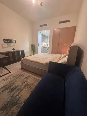 a bedroom with a bed and a desk in it at Azizi Riviera Luxury Studio with Grand Balcony in Dubai