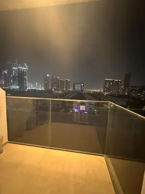a view of a city skyline at night at Azizi Riviera Luxury Studio with Grand Balcony in Dubai