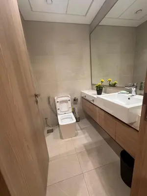 a bathroom with a sink and a toilet and a mirror at Azizi Riviera Luxury Studio with Grand Balcony in Dubai