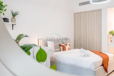 a living room with a bed and a couch at Just Steps Away from Circle Mall, Right Beside a Park, Near Restaurants, Conveniently Close to a Bus Stop, Lumina Vista Residences, Jumeirah Village Circle by Deluxe Holiday Homes in Dubai