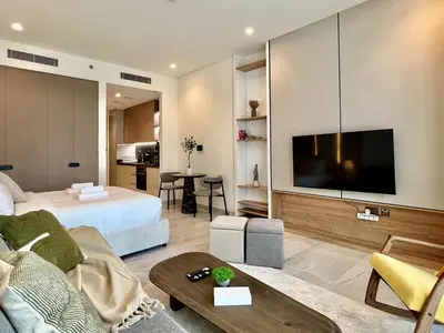a living room with a bed and a flat screen tv at DAYF-PENZOR Upgraded Studio for 4 with Full Burj View in Dubai
