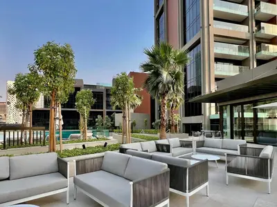 a patio with couches and tables in front of a building at DAYF-PENZOR Upgraded Studio for 4 with Full Burj View in Dubai