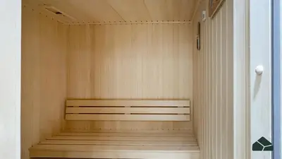 a sauna with a wooden bench in a room at Luxury Studio with Canal View and Jacuzzi by BMS in Dubai
