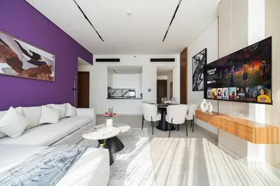 a living room with a couch and a table at SettlerHomes - Elite 2BR With Private Jacuzzi Oasis in Dubai