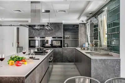 a kitchen with a counter with fruits and vegetables on it at DAYF-NIL Lux 5-BR Villa with Pool & Piano - Green Community in Dubai