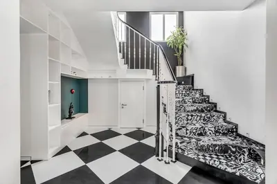 a staircase with a black and white checkered floor at DAYF-NIL Lux 5-BR Villa with Pool & Piano - Green Community in Dubai