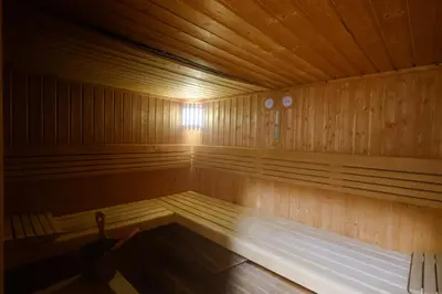 a large wooden sauna with a bench in it at Modern Studio with Marina Skyline view in JLT - Prime Location near Metro in Dubai