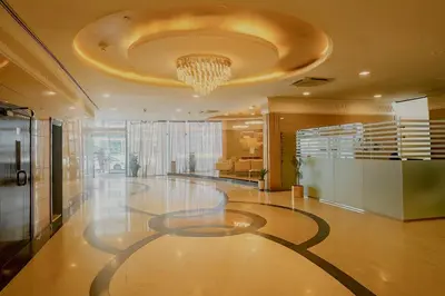 a large lobby with a chandelier on the ceiling at Modern Studio with Marina Skyline view in JLT - Prime Location near Metro in Dubai