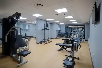 a gym with rows of treadmills and exercise equipment at Modern Studio with Marina Skyline view in JLT - Prime Location near Metro in Dubai