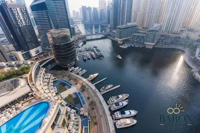 an aerial view of a city with boats in a river at The Serene in Dubai